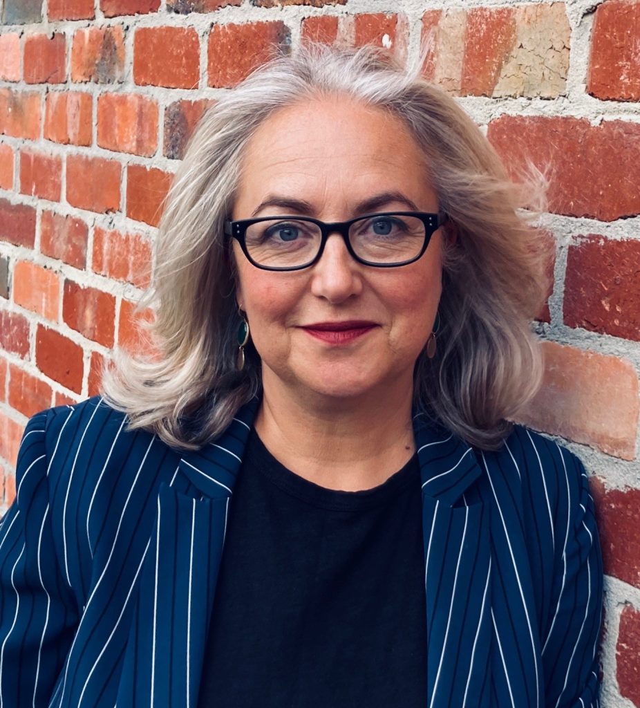 Dr Helen Durham picture in front of brick wall